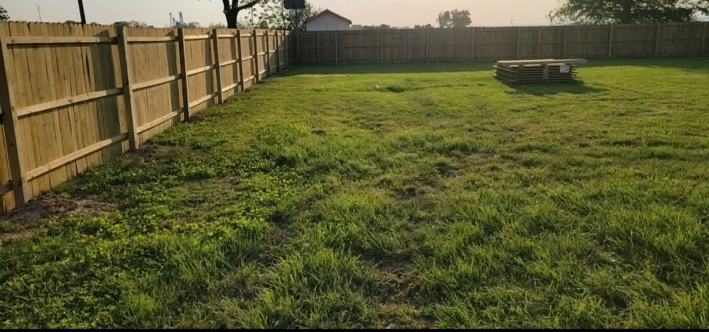 Large yard with newly installed wooden privacy fence